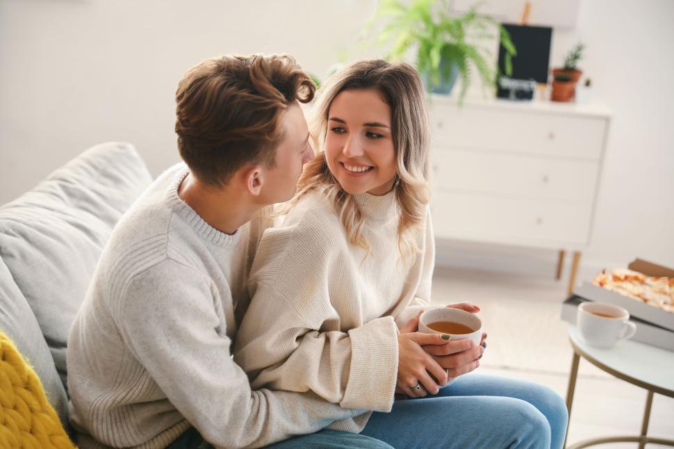 Free Image of A couple sharing a tender moment in their living room 