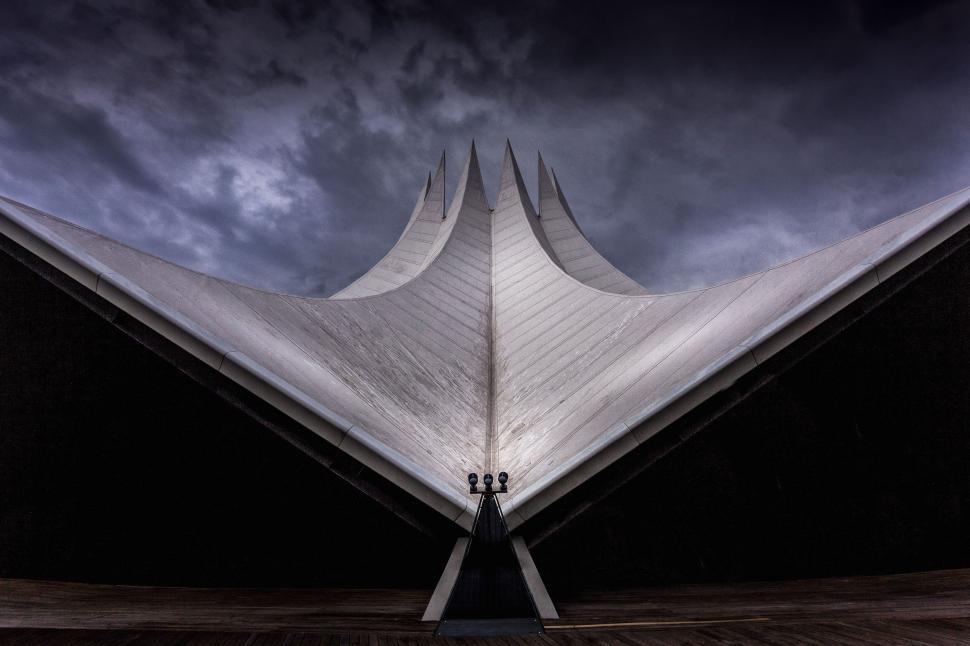 Free Image of Modern architectural structure with bleak sky background 