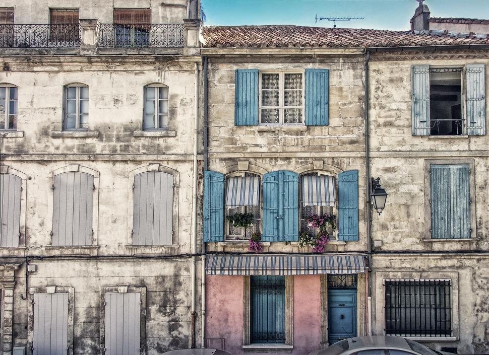 Free Image of Facades of old buildings with blue shutters and windowsills view. 