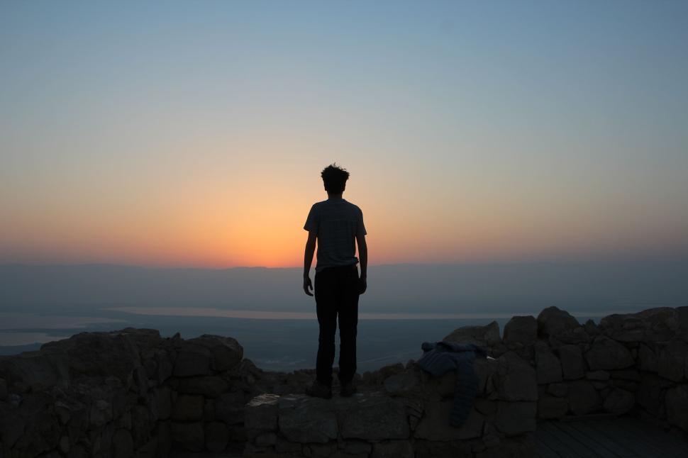https://freerangestock.com/sample/178695/silhouette-of-person-standing-amongst-ruins-at-sunrise-gazing-out..jpg