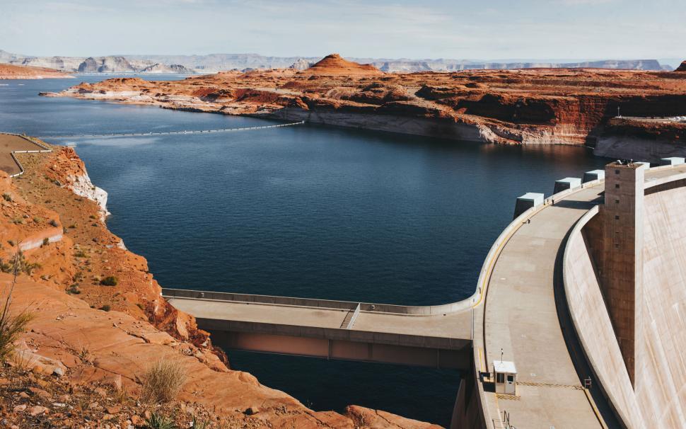 Free Image of Scenic view of large dam and expansive lake surrounded by hills 