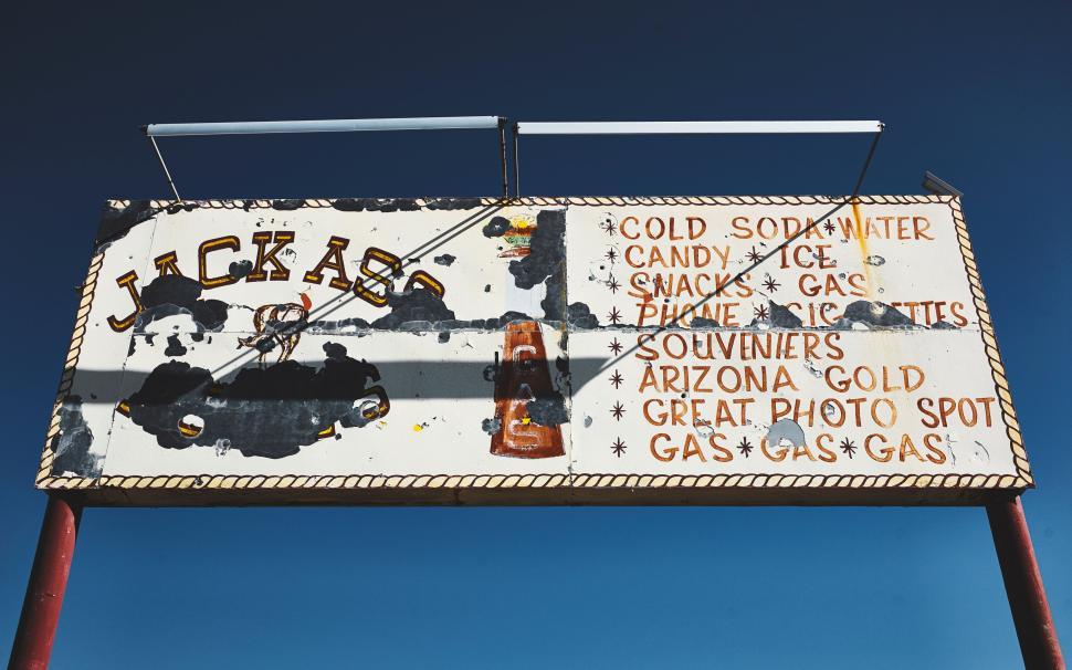 Free Image of Weathered vintage sign advertising candy, gas, and souvenirs 