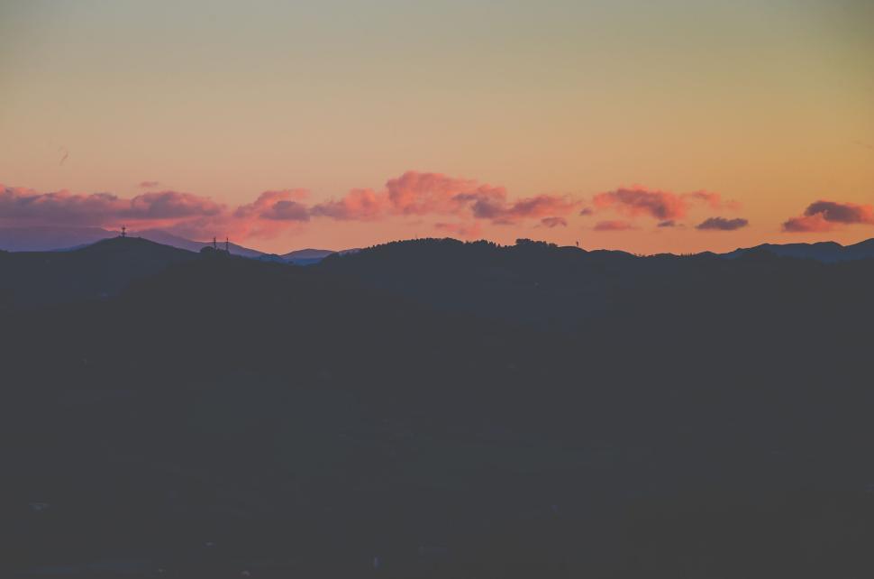 Free Image of Silhouette of hills with colorful dawn sky and scattered clouds 