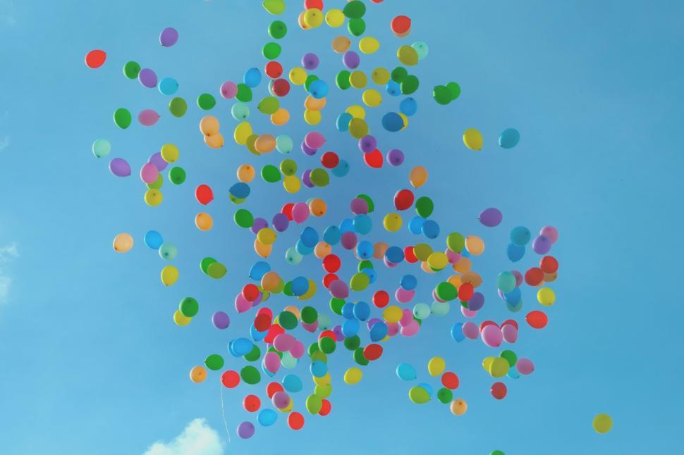 Free Image of Colorful balloons rising against a clear blue sky background 
