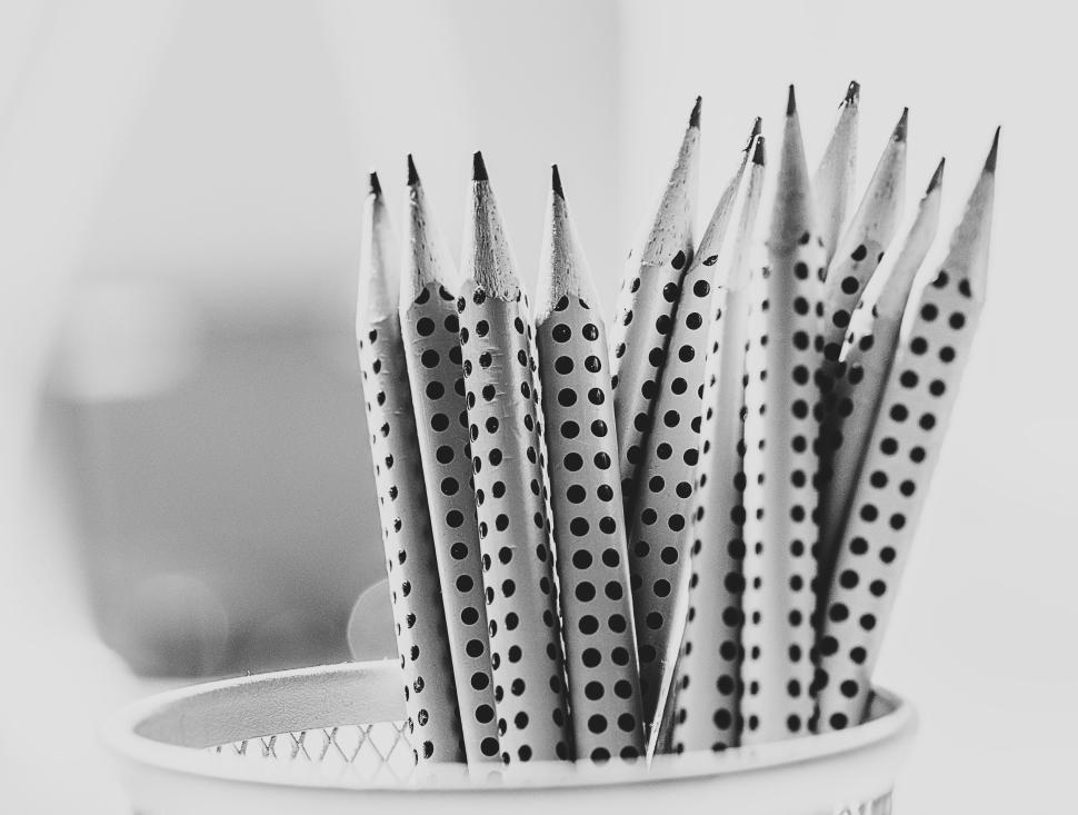 Free Image of Polka-dotted pencils neatly arranged in a white mesh holder 