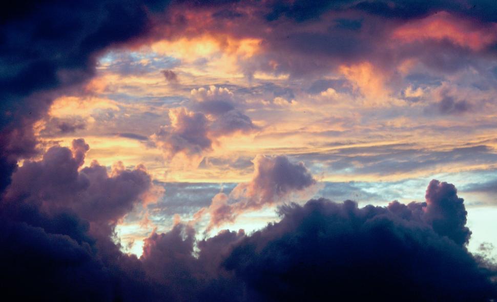 Free Image of Colorful dramatic clouds at sunrise with vibrant colors. 