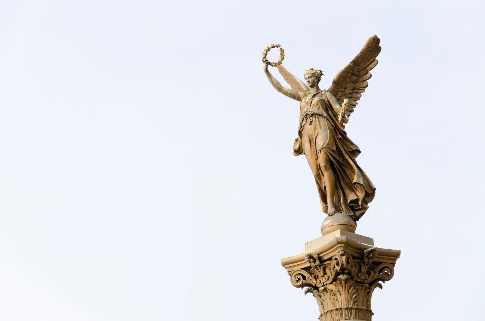 golden-angel-statue-holding-a-wreath-on-