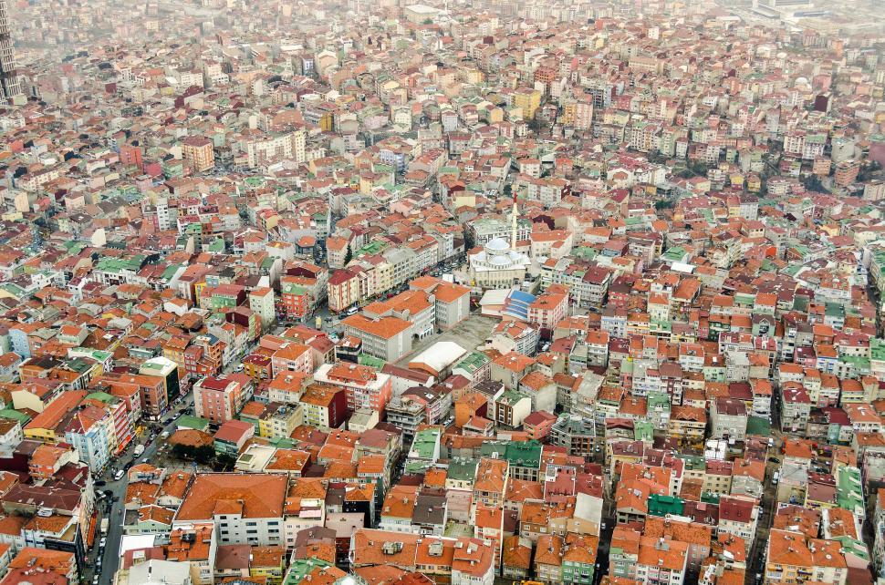 Free Image of Aerial view of a densely packed cityscape with vibrant rooftops 