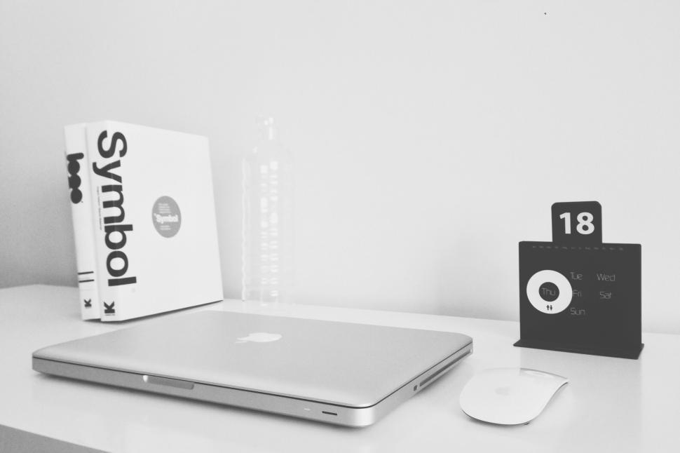 Free Image of Minimalistic desk setup with laptop, books, mouse and modern calendar 