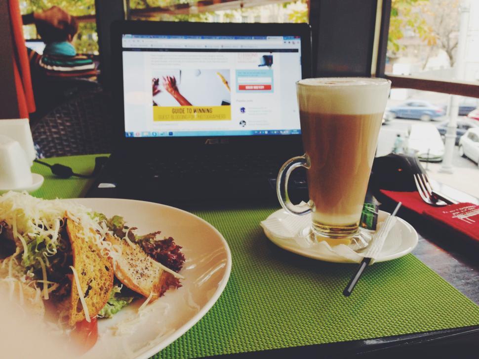 Free Image of Laptop and coffee on a table with a side salad and biscuits 