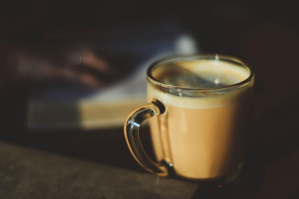 Free Image of Close-up shot of a cup of coffee in a transparent glass cup indoors. 