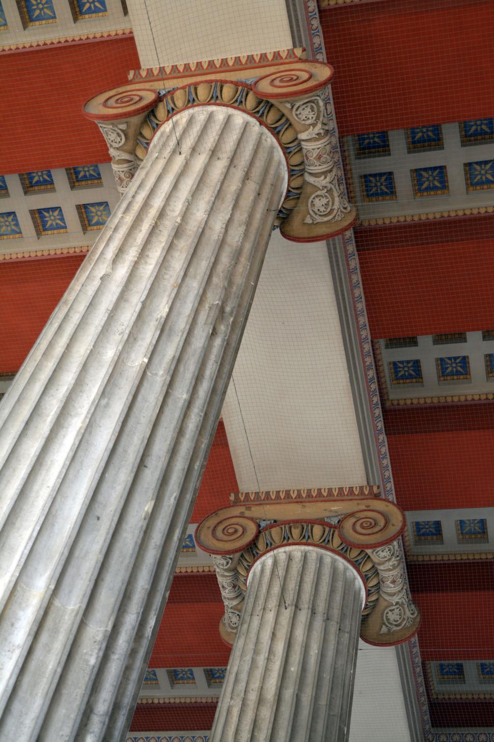 Free Image of Ancient Greek columns with ornately decorated capitals and ceiling 