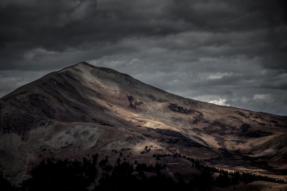 Free Image of Dark mountain under ominous cloudy sky at twilight scene 