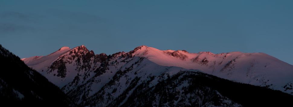 Free Image of Sunrise illuminating snowy mountain peaks in winter 