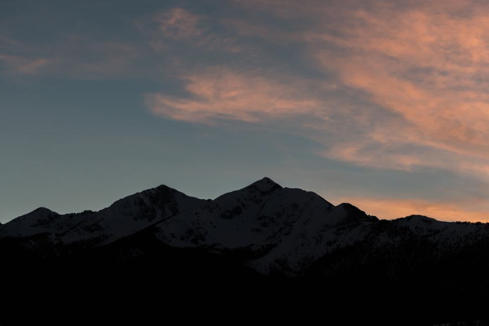 Free Image of Silhouette of mountains at sunset with orange sky 