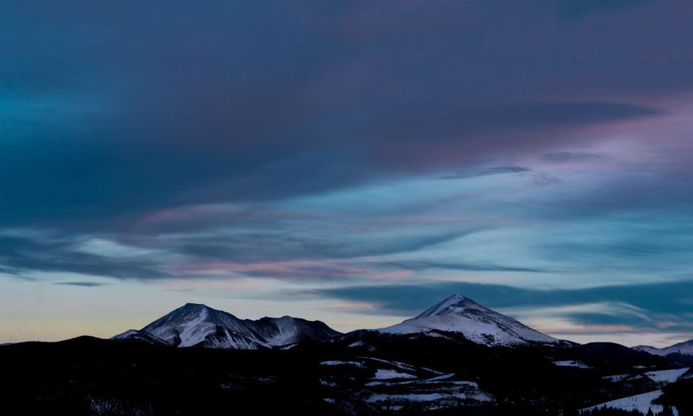 Free Image of Twilight mountain view with snow under colorful sky 