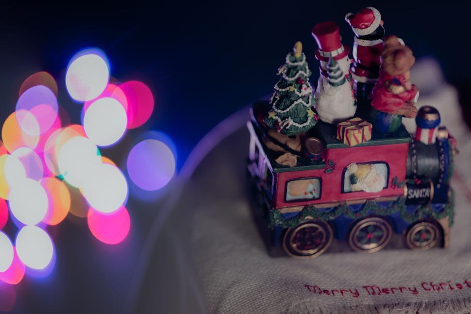 Free Image of Festive Christmas train decoration with colorful bokeh. 