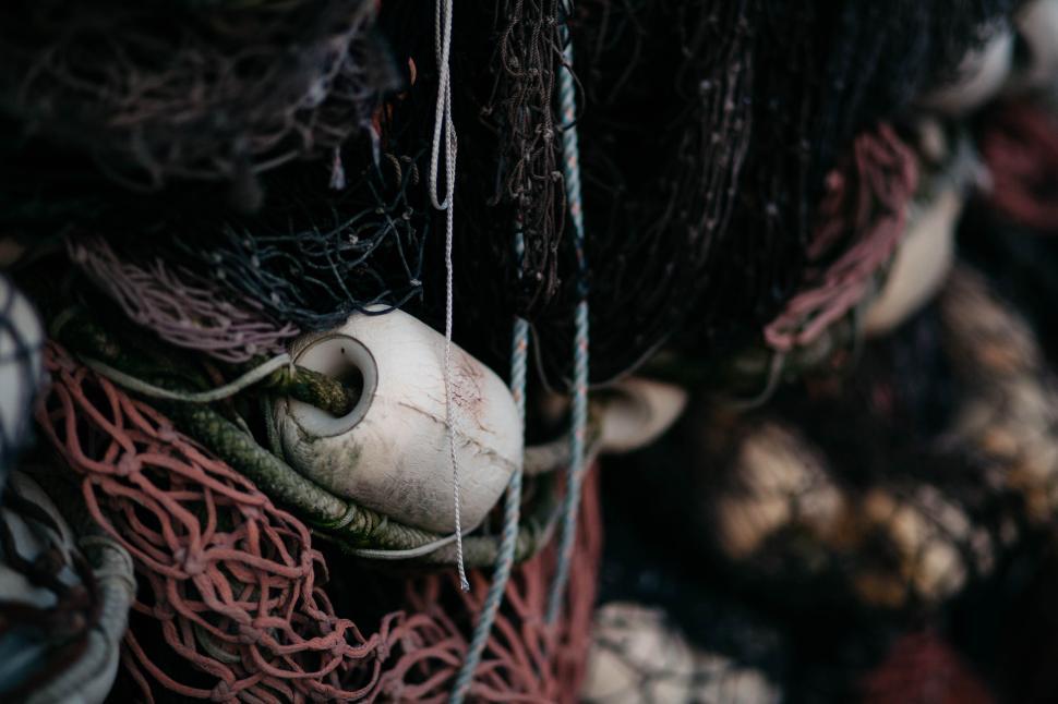 Free Image of Close-up of fishing nets tangled with floaters and ropes 