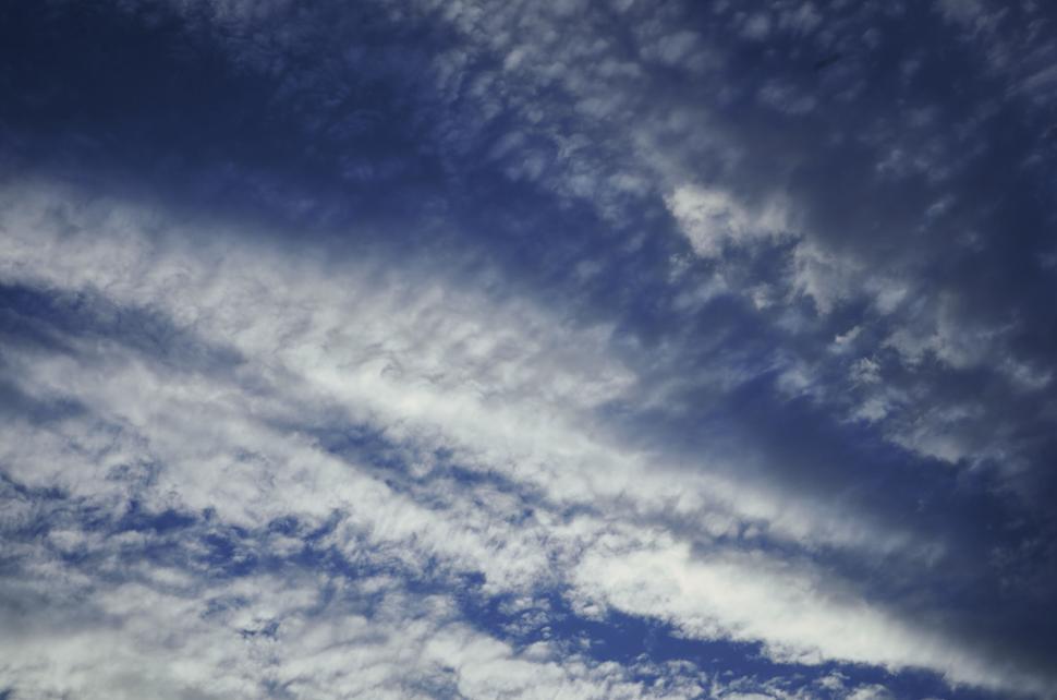 Free Image of Sky filled with fluffy white clouds on a sunny day. 