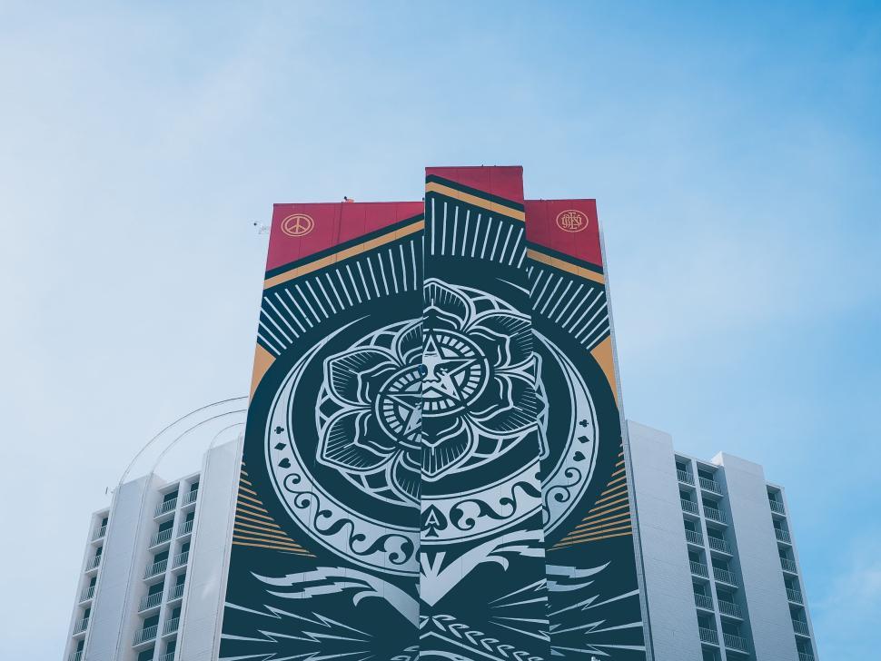 Free Image of Colorful mural painting on tall building under blue sky. 