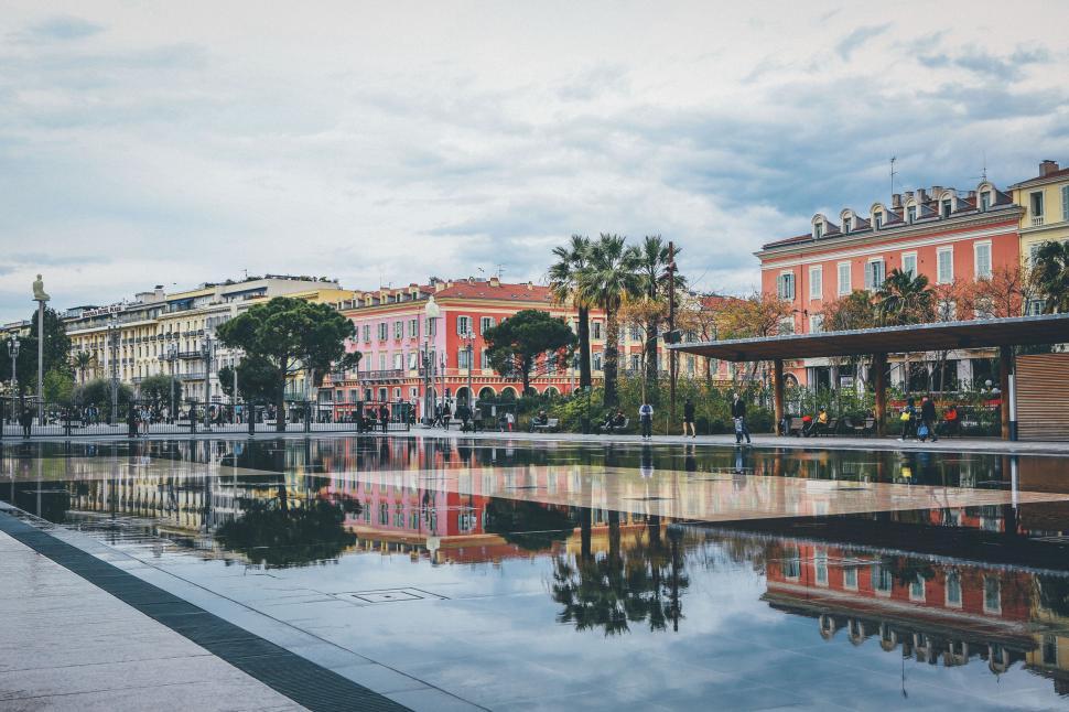 Free Image of Colorful buildings reflecting on a calm water surface 