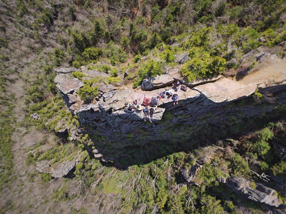 Free Image of Aerial view of group resting atop a rocky cliff. 