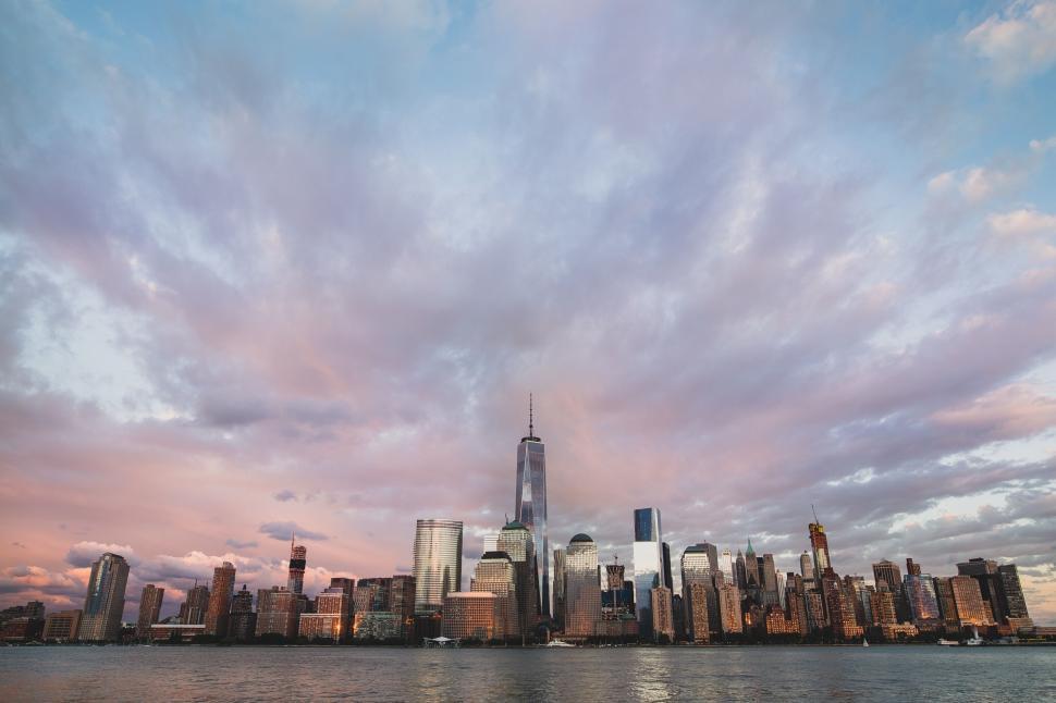 Free Image of City skyline with towering skyscrapers at sunset time 