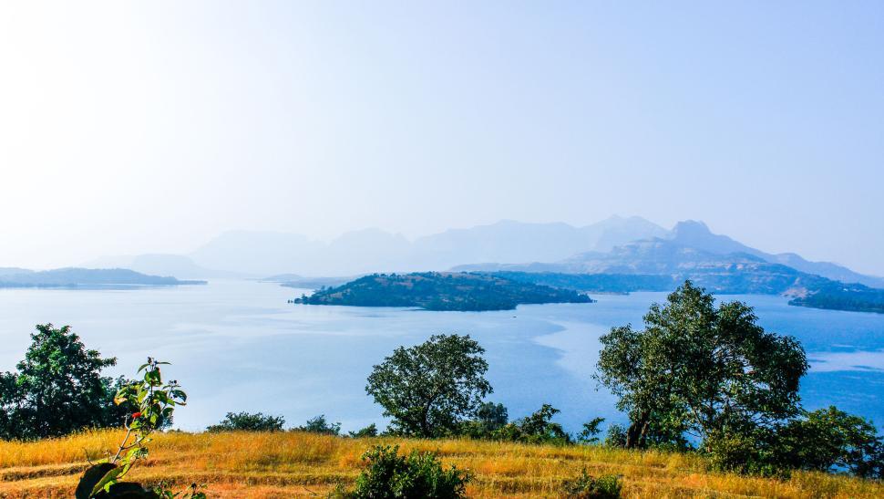 Free Image of Scenic lake view with islands and distant mountains. 