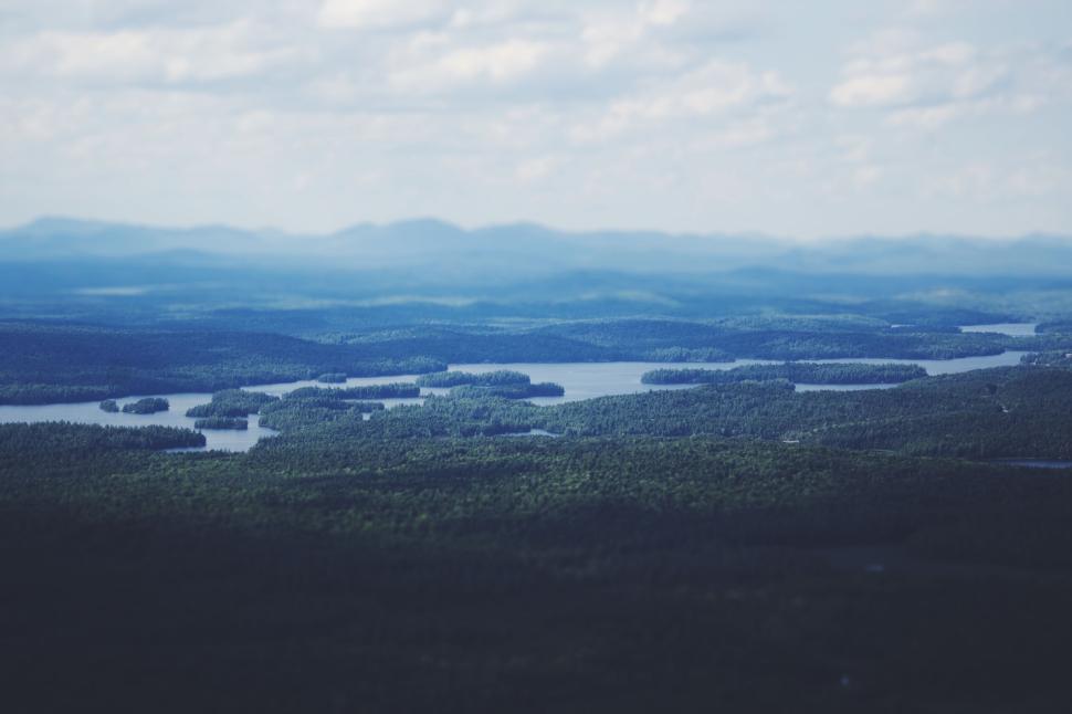 Free Image of Sweeping vista of lakes and forests under cloudy sky 
