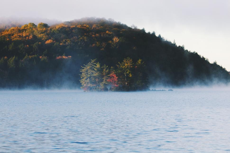 Free Image of Misty lake and small island with trees and autumn foliage. 