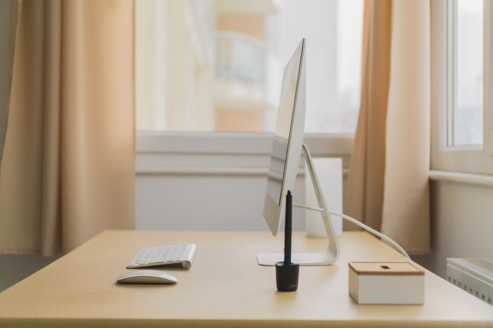 Free Image of Desktop computer and accessories on a light desk. 