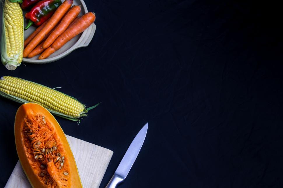 Free Image of Variety of fresh vegetables and knife on dark surface 