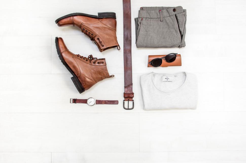 Free Image of Men’s accessories and clothing arranged on white floor 