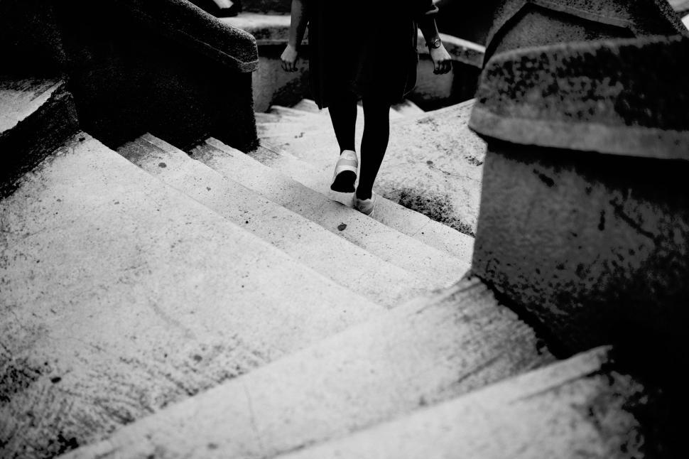 Free Image of Black and white photo of person descending concrete stairs 