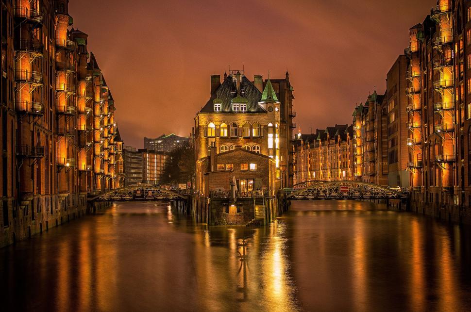 Free Image of Historic warehouse district alongside tranquil waterway. 