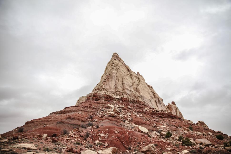 Free Image of Rustic red rock mountain peak under a cloudy sky 