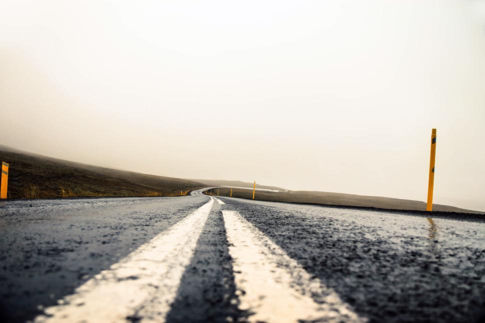 Free Image of Empty wet road disappearing into the mist 