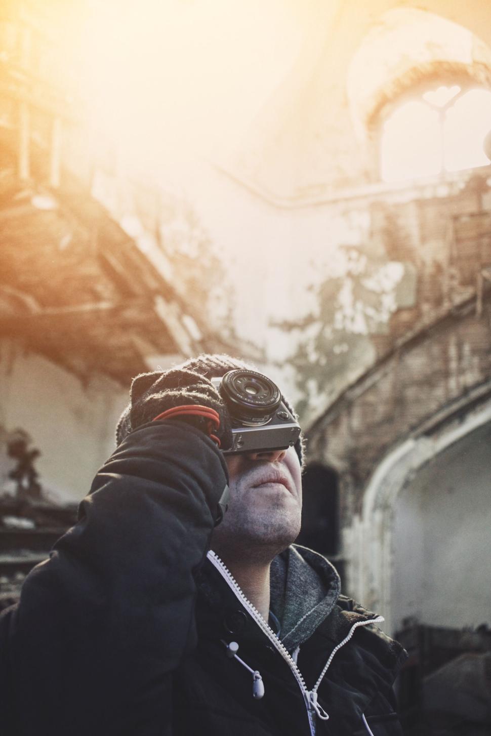Free Image of Photographer capturing shot in abandoned building interior. 