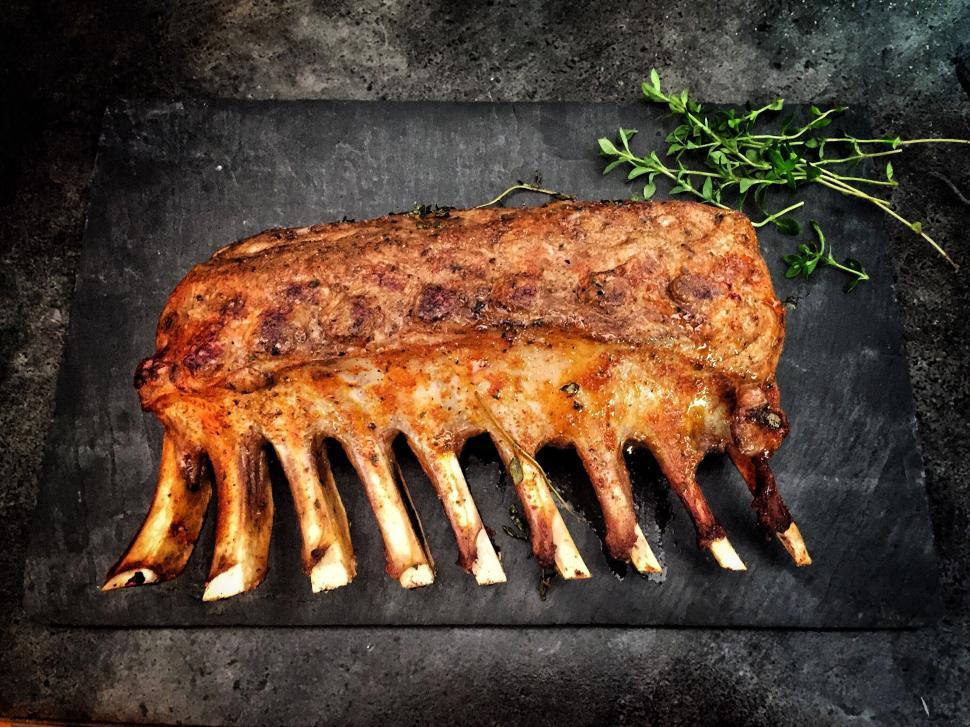 Free Image of Perfectly roasted rack of lamb with fresh thyme herb 