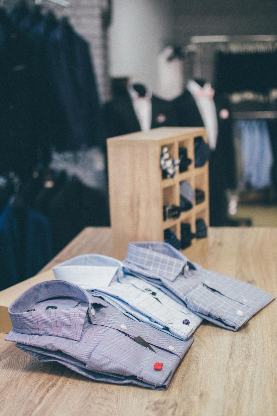 Free Image of Three neatly folded dress shirts on a wooden table 