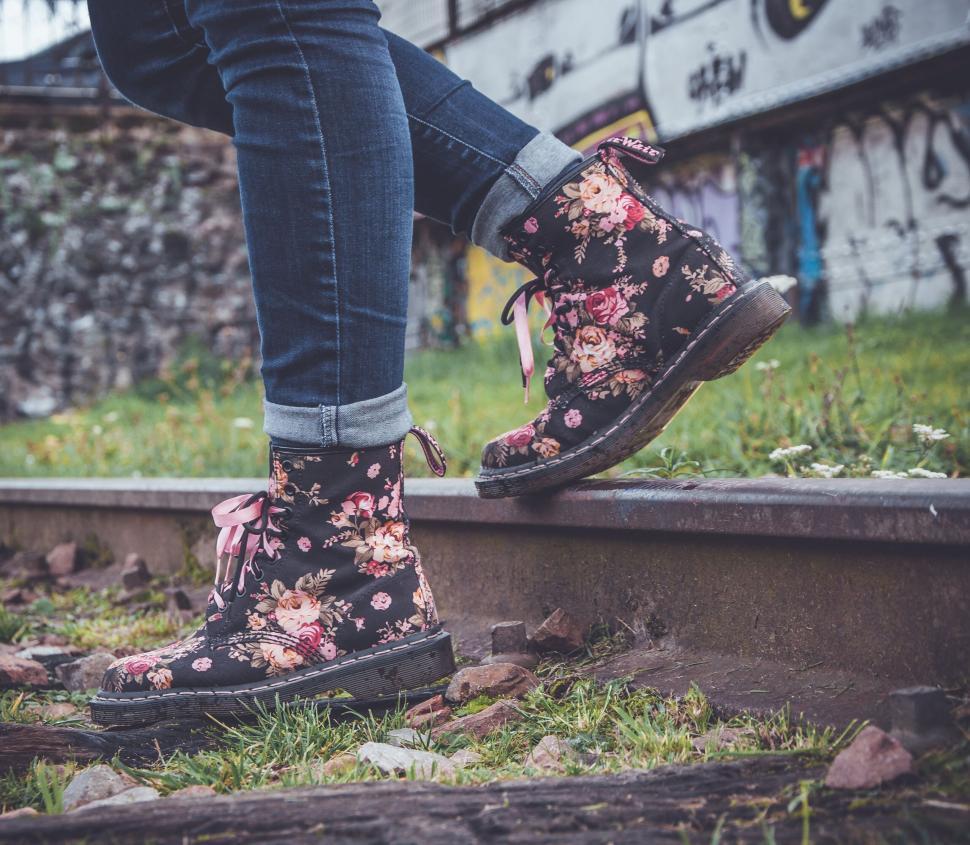 Free Image of Person wearing floral printed boots standing on railway 