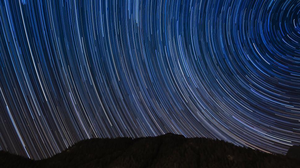 Free Image of Star trails over mountains, night sky, celestial motion. 