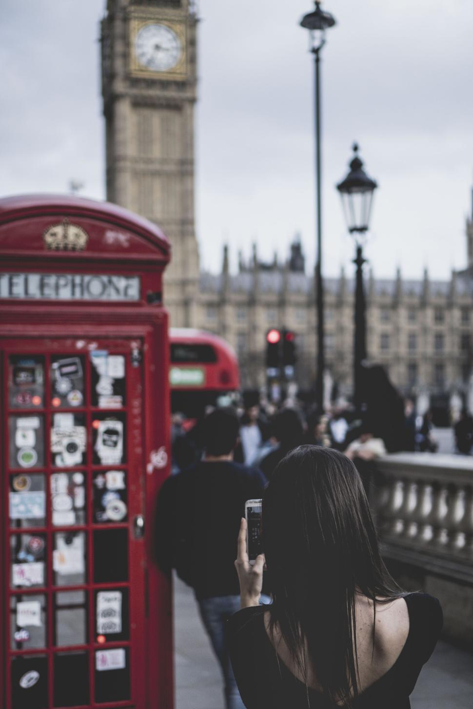 tourist-capturing-sights-near-iconic-telephone-booth.jpg