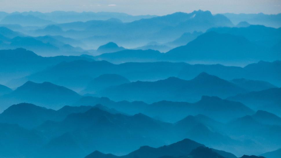 Free Image of Blue tinted mountain ranges spreading into horizon 