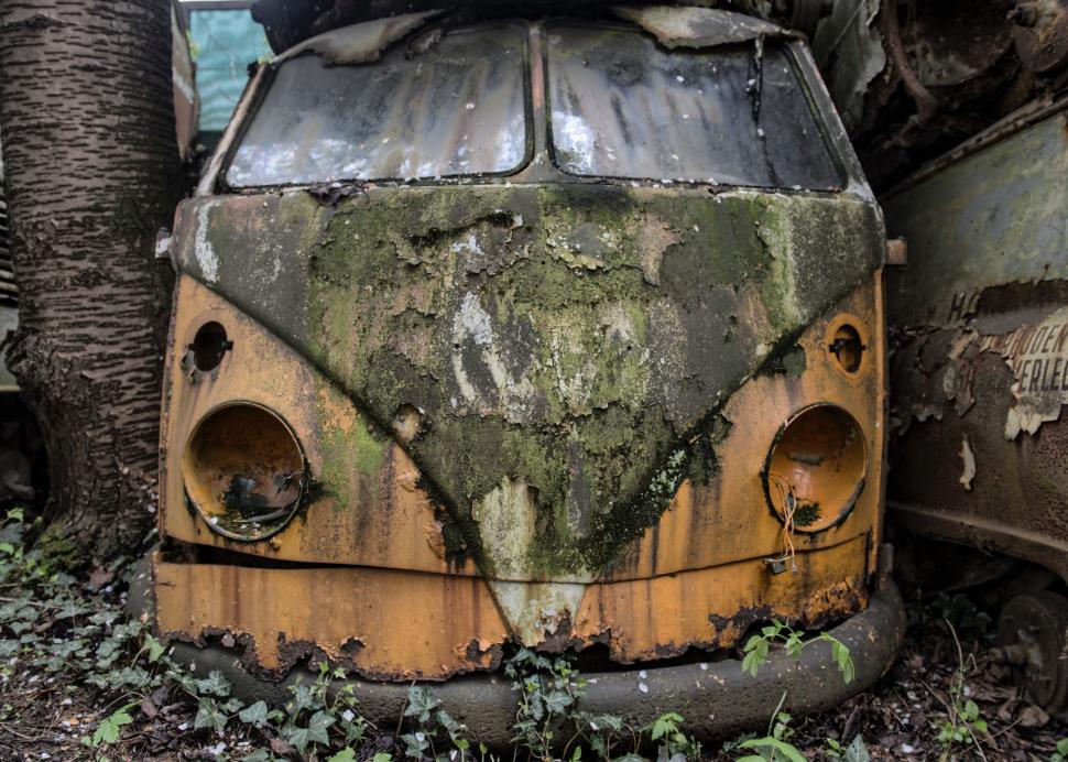 Free Image of Abandoned vintage van covered with moss in nature. 
