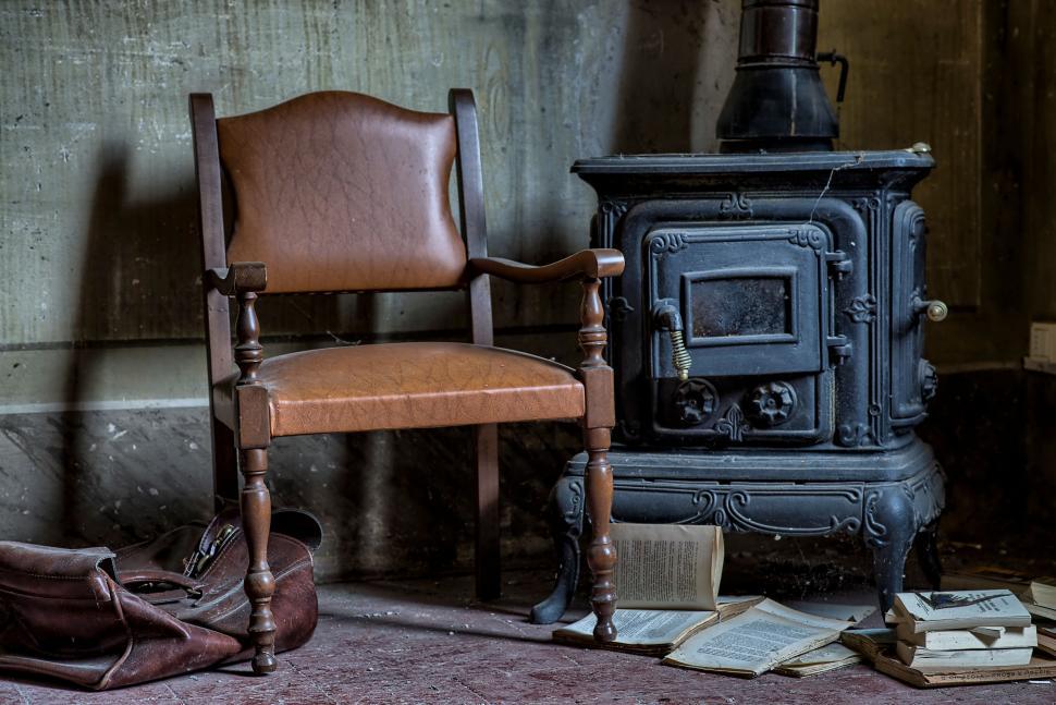 Free Image of Vintage chair and stove in abandoned rustic room 