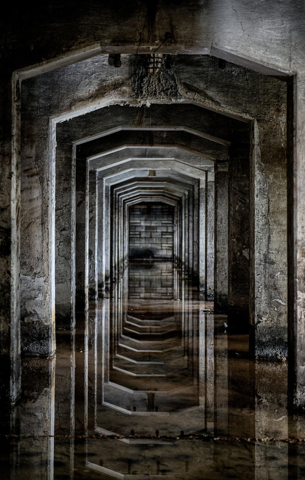 Free Image of Concrete corridor reflecting in water, industrial scene 
