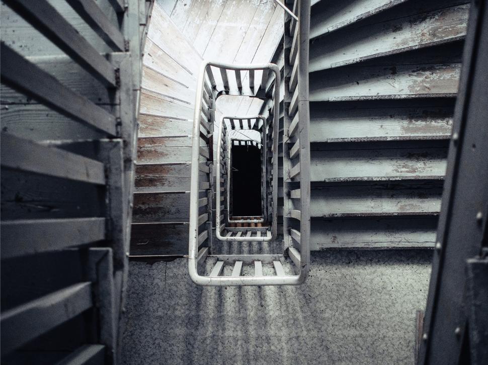 Free Image of Top-down view of spiral staircase with metal railing. 