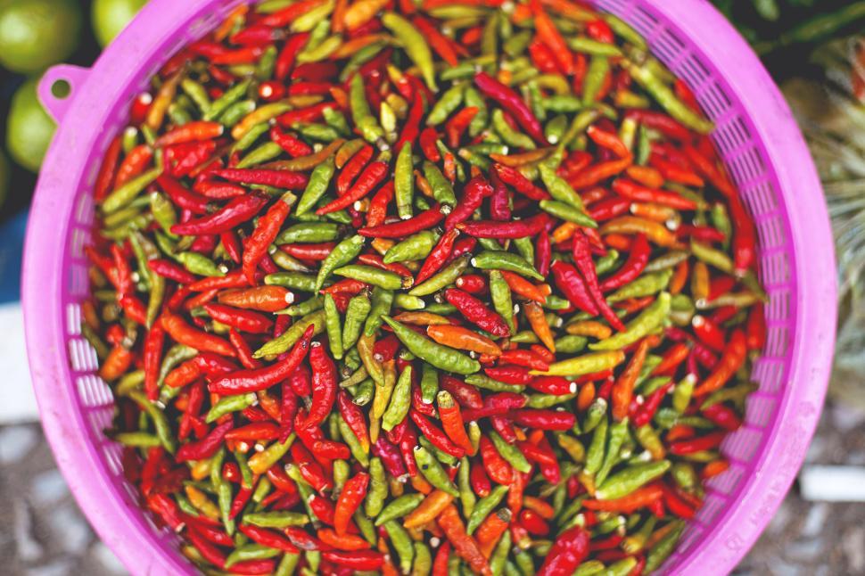 Free Image of Colorful mix of red and green chili peppers in basket 