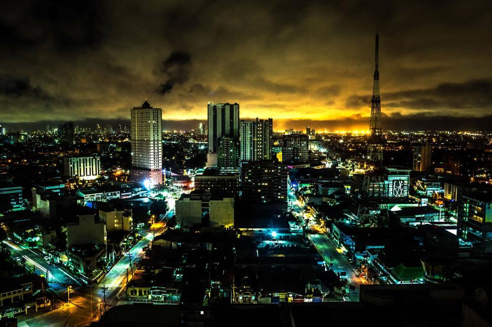 Free Image of City skyline at night with illuminated buildings and sky 
